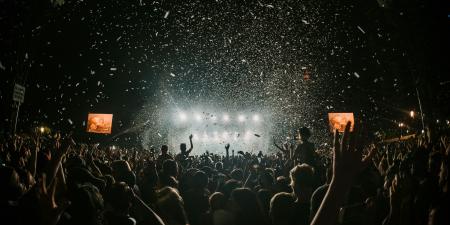 Festival goers enjoy a music festival in darkness
