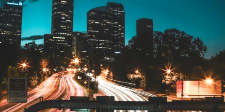 Night time view of Sydney CBD skyline and long exposure of roads