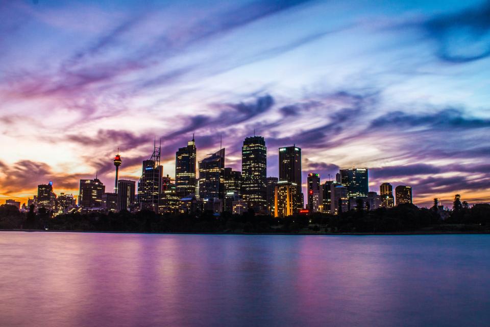 The Sydney CBD building skyline at dusk as seen from the water.